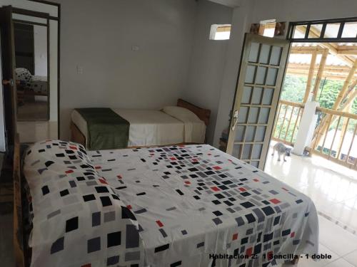 a bedroom with a bed and a door with a dog at El Guadual Casa Campestre in Ibagué