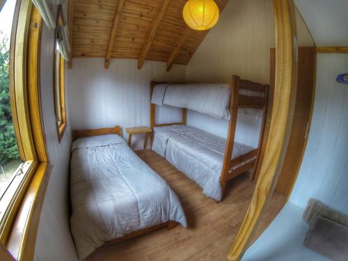a small room with a bed and a bunk bed at AWEN in Lago Meliquina