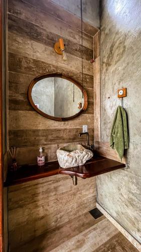a bathroom with a sink and a mirror at Pousada dos Sonhos - MP in Miguel Pereira