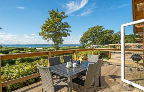 a patio with a table and chairs on a deck at Pet Friendly Home In Tranekær With Wifi in Tranekær