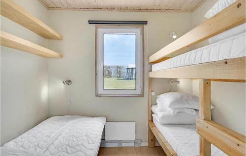 a small bedroom with two bunk beds and a window at Pet Friendly Home In Tranekær With Wifi in Tranekær