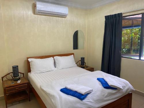 a bedroom with a bed with towels on it at Villa Blue Lagoon in Sihanoukville