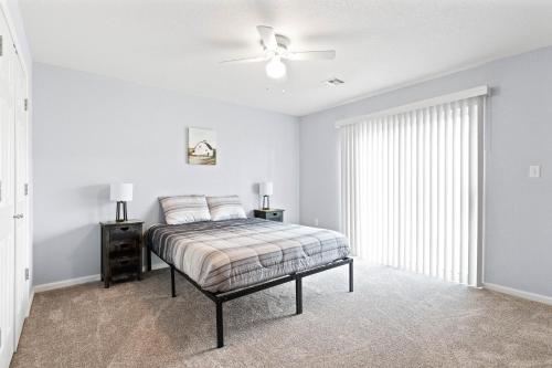 a bedroom with a bed and a ceiling fan at New King Bed Beautifully Updated KMC1312 in Manhattan