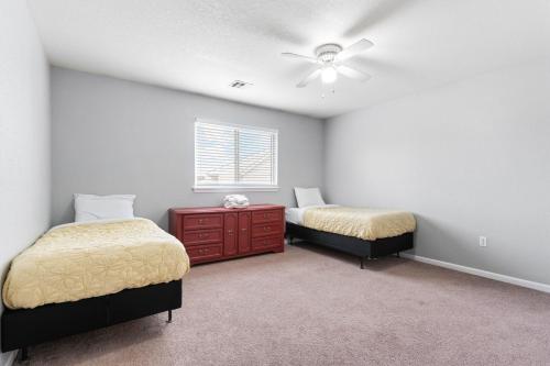 a bedroom with two beds and a red dresser at End Unit, King Bed, Garage and Free Parking KMN1312 in Manhattan