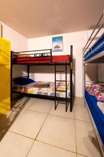 a room with two bunk beds in a room at KIA ORA Lodge in Afaahiti