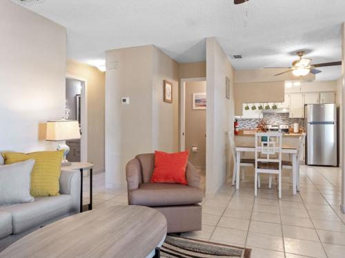 a living room with a couch and a chair and a kitchen at Island-Life! A in Fort Pierce