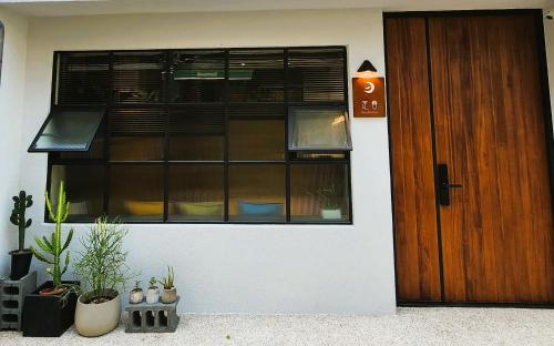 un edificio con una ventana con plantas y una puerta en 定春行旅 Haru Guesthouse, en Tainan