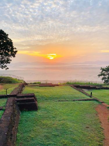 a view of the sunset from the top of a hill at Sigiri Saman Home Stay in Sigiriya