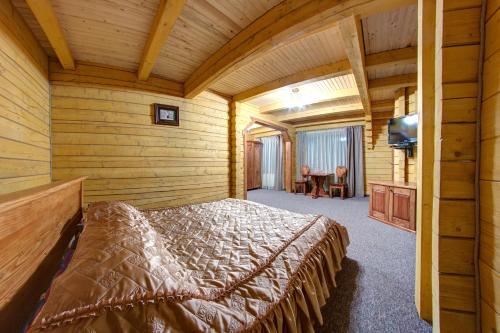 ヤレムチャにあるKarpatski Dzherelaの丸太小屋のベッドのある寝室