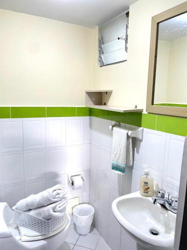 a white bathroom with a sink and a toilet at Hermoso apartaestudio moderno valle de atriz norte in Pasto