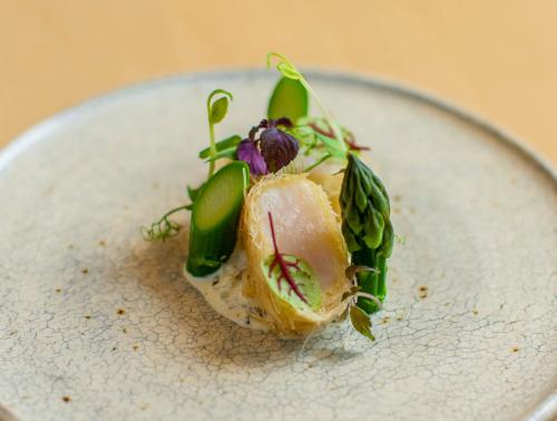 a white plate with a piece of food on it at Yoichi LOOP in Kurokawamachi