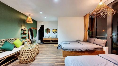 a bedroom with a bed and a couch and a mirror at Nhà Sói Homestay Da Lat in Da Lat