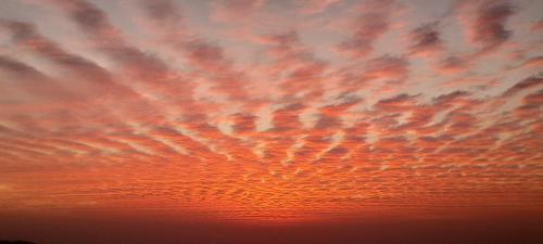a sunset with clouds in the sky at Paradise Villa in Nagarkot