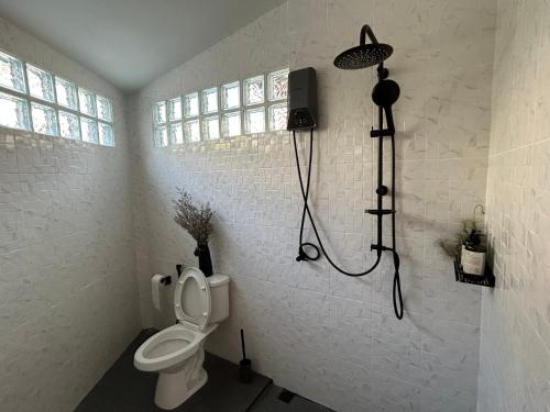 a bathroom with a toilet and a shower at Cozy villa in Chiangmai old town in Chiang Mai