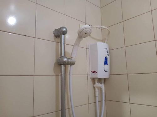 a white hair dryer is attached to a wall at Alabang Condotel in Manila