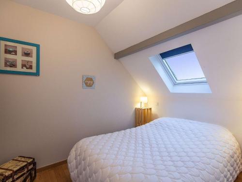 a bedroom with a large white bed with a skylight at Maison Luz-Saint-Sauveur, 3 pièces, 4 personnes - FR-1-402-130 in Luz-Saint-Sauveur