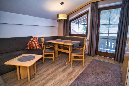 a living room with a table and chairs and a couch at Ferienhof Stöckl in Finkenberg