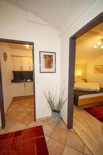 a living room with a bed and a kitchen at Ferienhof Stöckl in Finkenberg