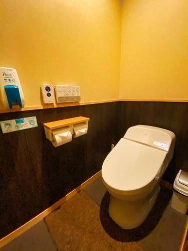 a bathroom with a white toilet in a room at Ryokan Sawaya Honten in Kyoto