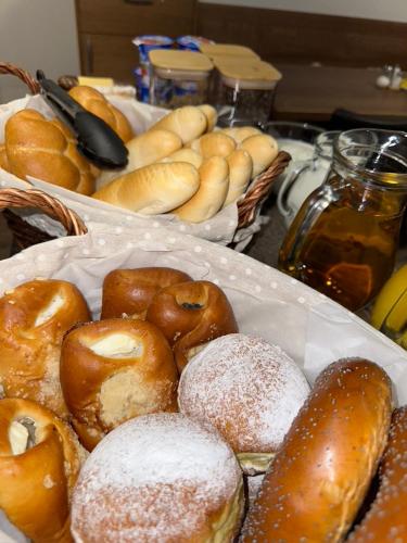 two baskets of different types of donuts on a table at SYNEK Pension in Špindlerův Mlýn