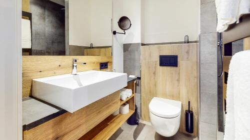 a bathroom with a white sink and a toilet at Point 7 Hotel in Fulda