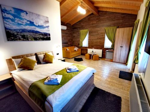 a bedroom with a bed with two towels on it at POPASUL LU' VODĂ in Borşa