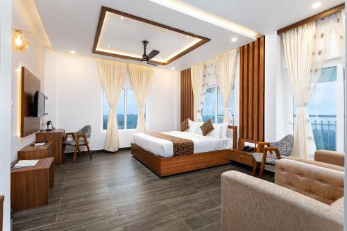 a hotel room with a bed and a living room at Ramee Wolkenburg Resort & Spa, Munnar in Munnar