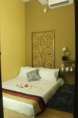 a bedroom with a bed with a large headboard at 1 MINUTES TO TOWER SENTRAL INTAN HOMESTAY 6 ROOMS in Teluk Intan