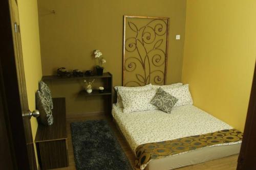 a small bedroom with a bed and a door at 1 MINUTES TO TOWER SENTRAL INTAN HOMESTAY 6 ROOMS in Teluk Intan