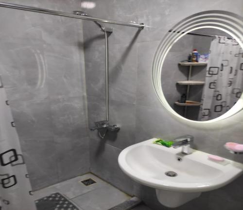 a bathroom with a sink and a mirror at شاليهات فندقيه منتجع Porto said in Port Said