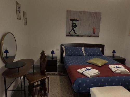 a bedroom with a bed and a table and a mirror at Abate Luxury Interno 3 in Bari