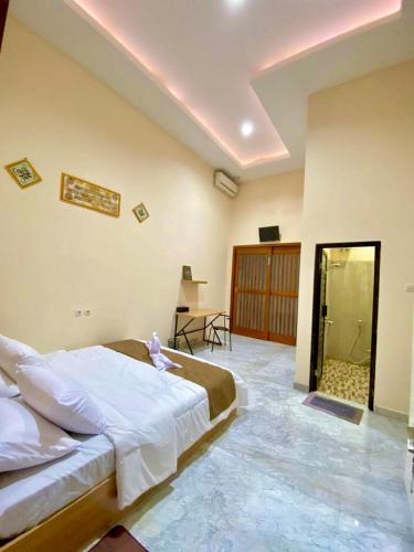 a bedroom with a large bed in a room at Al-Kiswah Syariah Guest House in Blitar