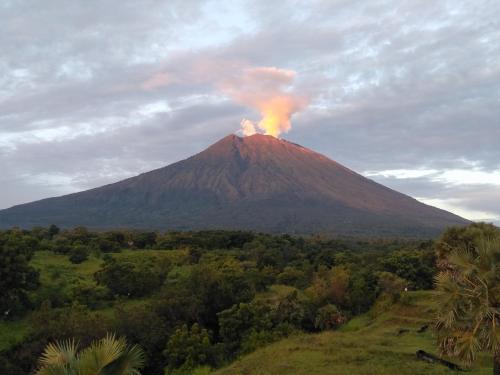 a mountain with a fire on top of it at Palm Springs Bali Dive Resort in Tulamben