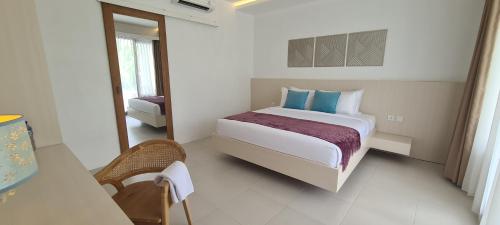 a bedroom with a large bed in a room at Palm Springs Bali Dive Resort in Tulamben