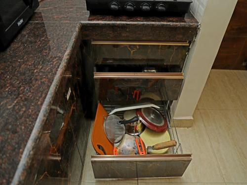 a drawer in a counter with tools in it at Yogvan Luxury 1BHK Apartments Tapovan Rishikesh in Rishīkesh