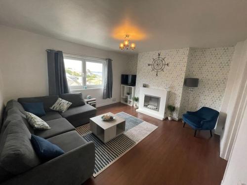 a living room with a couch and a fireplace at Beachfront Treasure in Musselburgh