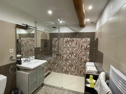 a bathroom with a sink and a shower at chambres d hotes Le Mas Julien piscine chauffée adult only in Orange