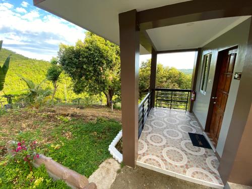 a view from the outside of a house with a balcony at MS Mountain Cabin in Loboc