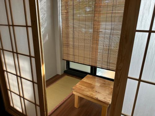 a small room with a wooden table and a window at Tatami D'Tepi Laut - PANGKOR ISLAND in Pangkor