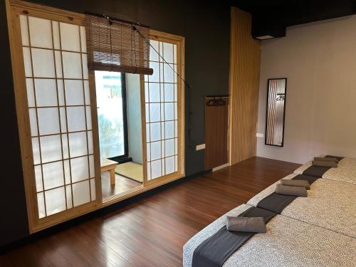 a room with a room with windows and a rug at Tatami D'Tepi Laut - PANGKOR ISLAND in Pangkor