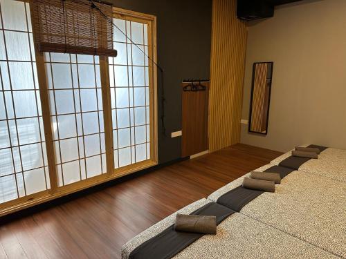 a room with a large room with large windows at Tatami D'Tepi Laut - PANGKOR ISLAND in Pangkor