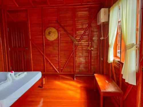 a bathroom with a sink and a wooden floor at Winyanz Tambayan Tourist Inn in Siquijor