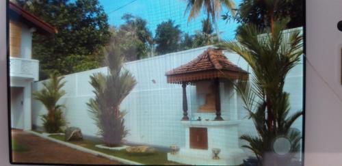 a white building with a gazebo in front of it at Sujee Villa White House in Beruwala