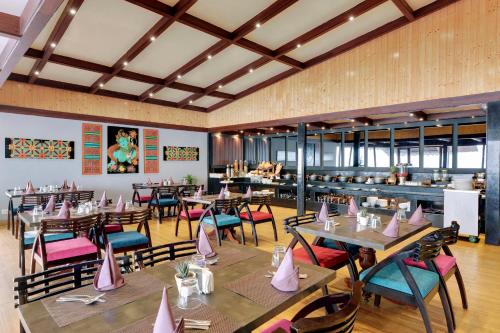 a dining room with wooden tables and chairs at Sumitel Vista 800m from Mall Road in Darjeeling