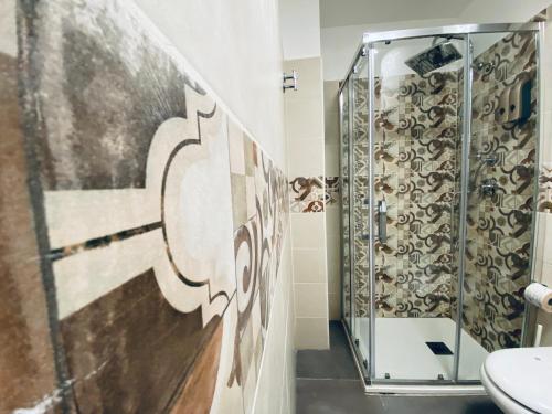 a bathroom with a shower and a toilet at I Cinque Mori DEVA in Siracusa