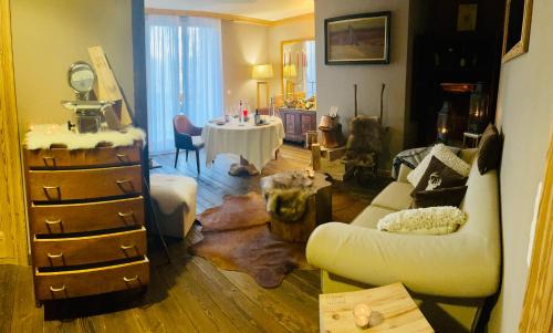 a living room with a couch and a table at Hotel Royal in Crans-Montana
