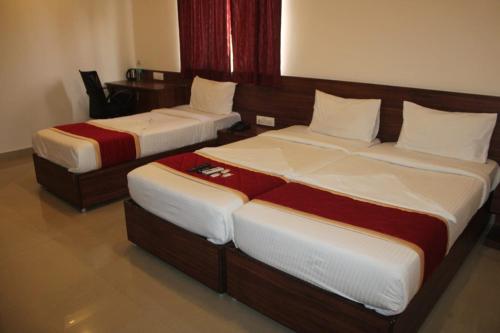 Cama o camas de una habitación en Hotel Passport Inn By WB Inn