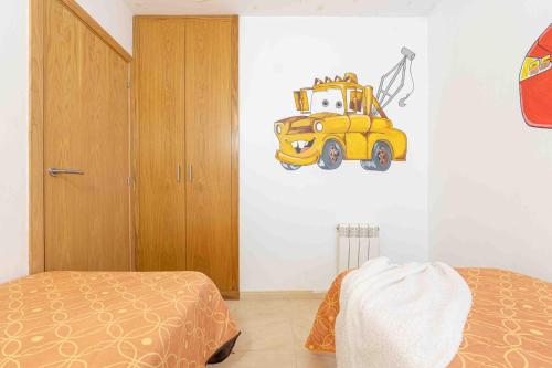 a bedroom with a painting of a yellow bus on the wall at Goldhome - Cristallmar in Empuriabrava