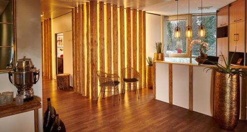 a living room with a kitchen with a counter and a table at Hotel Fontana in Bad Kissingen