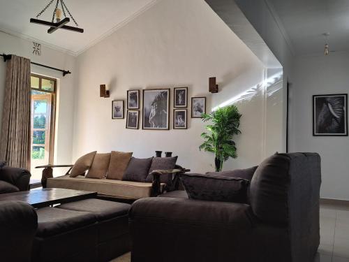 a living room with two couches and a table at Enaiteru in Oyugis